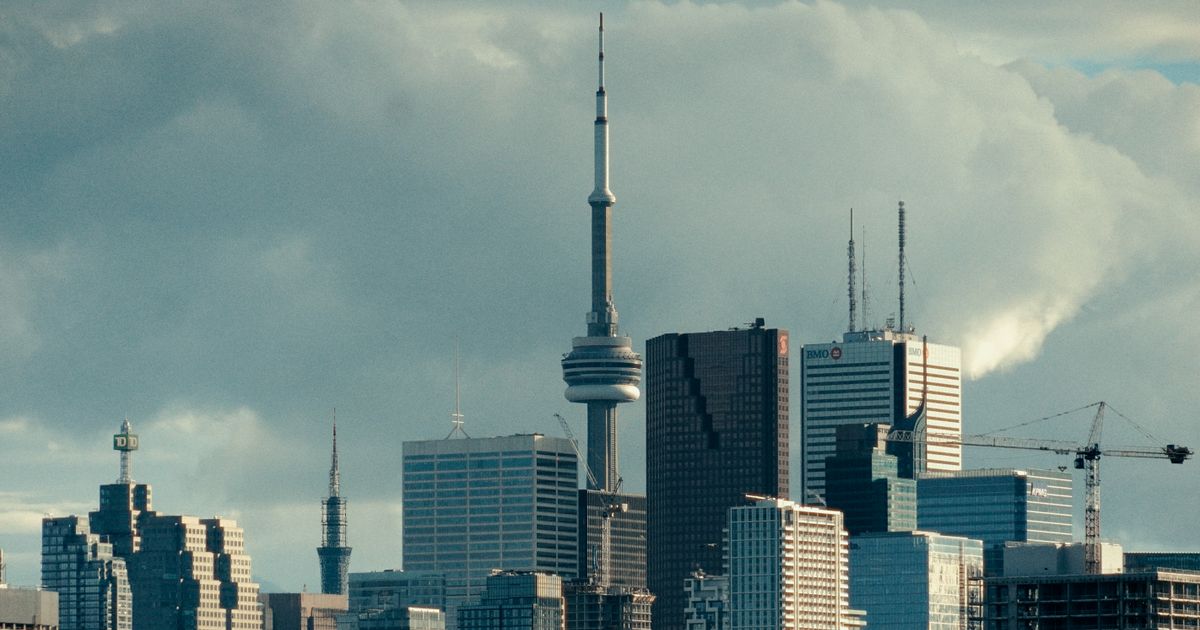 Stunning view of Toronto's skyline featuring the iconic CN Tower under cloudy skies.