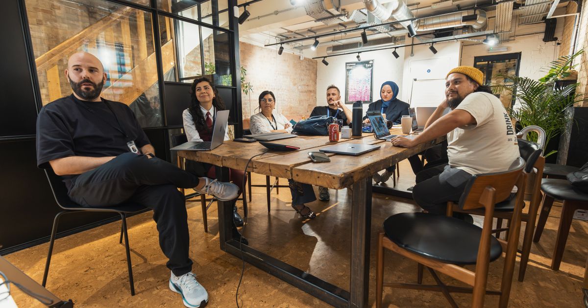 Diverse team engaged in a collaborative meeting in a contemporary office space.