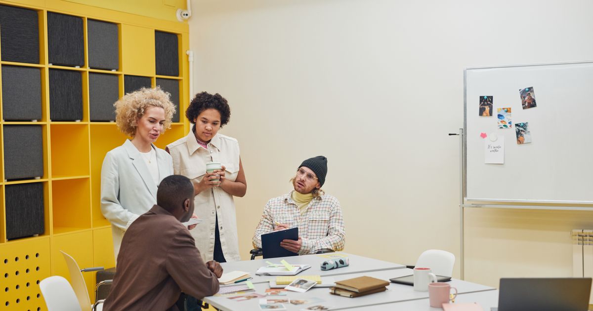 A diverse group of professionals having a collaborative meeting in a modern office space.